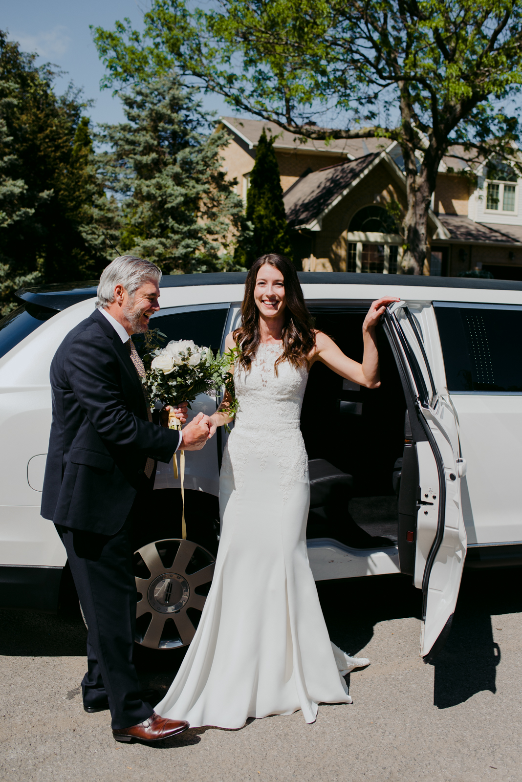 bride getting out of limo with her dad