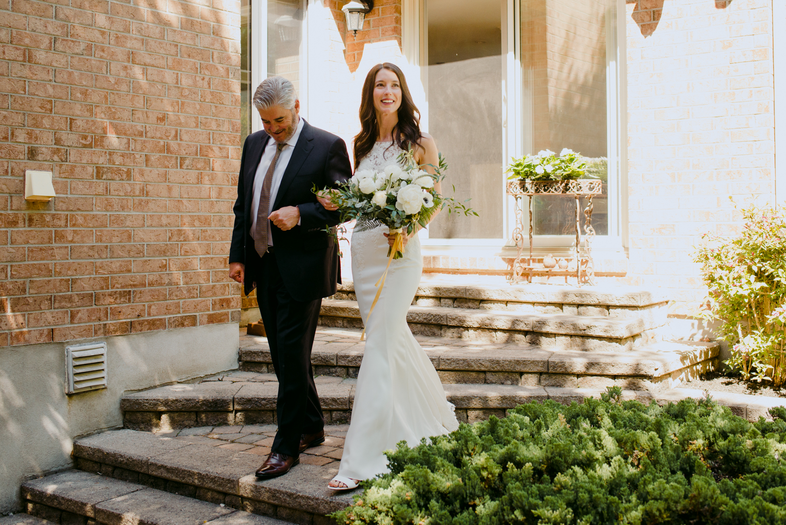 bride and her father walking down the steps during wedding ceremony