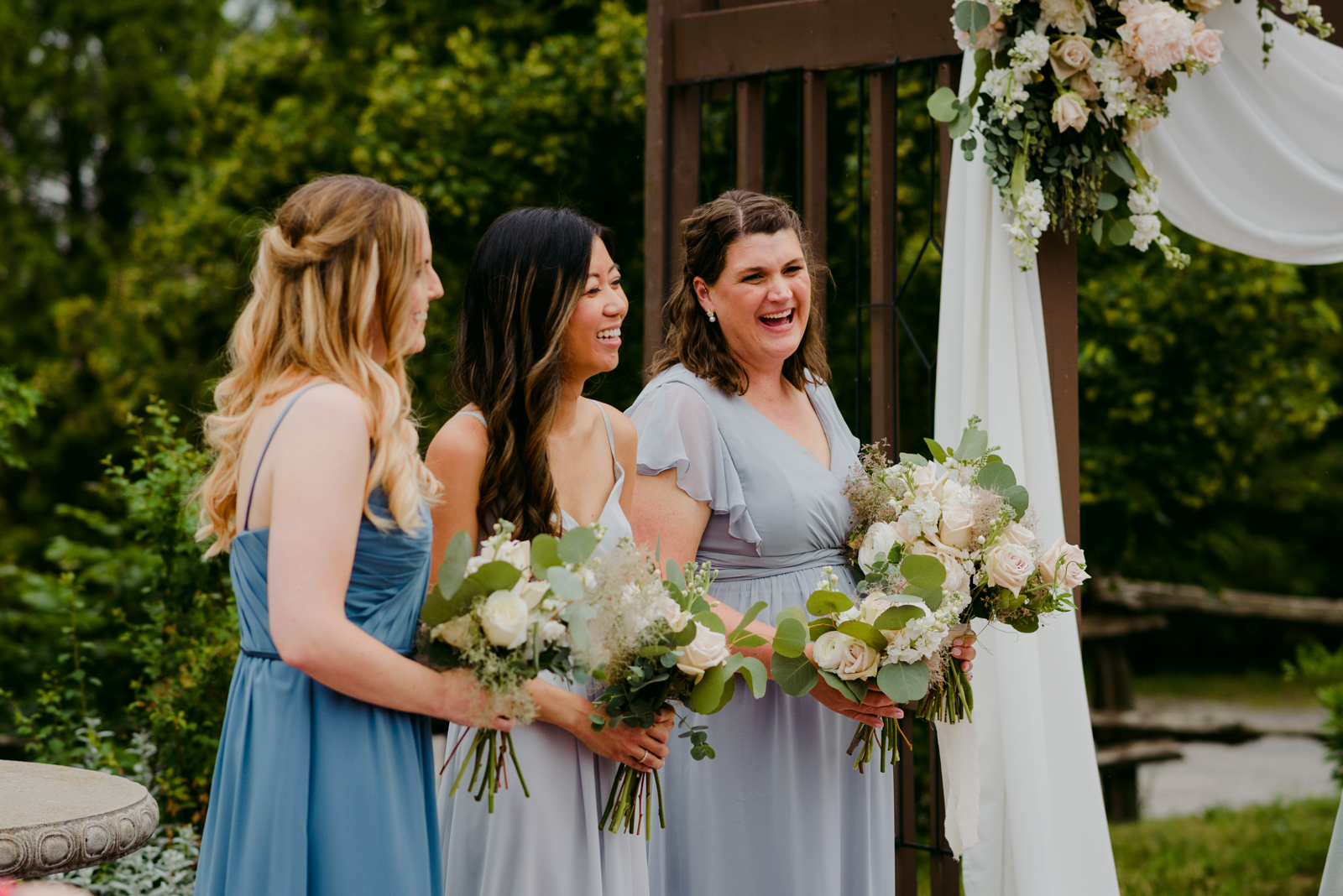 bridesmaids laughing during wedding ceremony at Strathmere