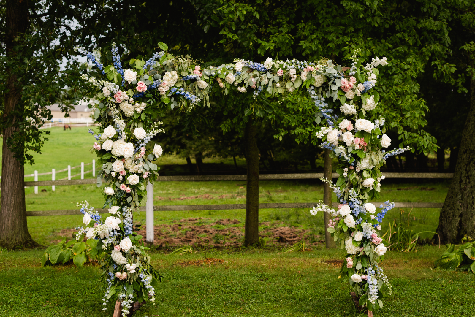 floral arch for outdoor wedding ceremony