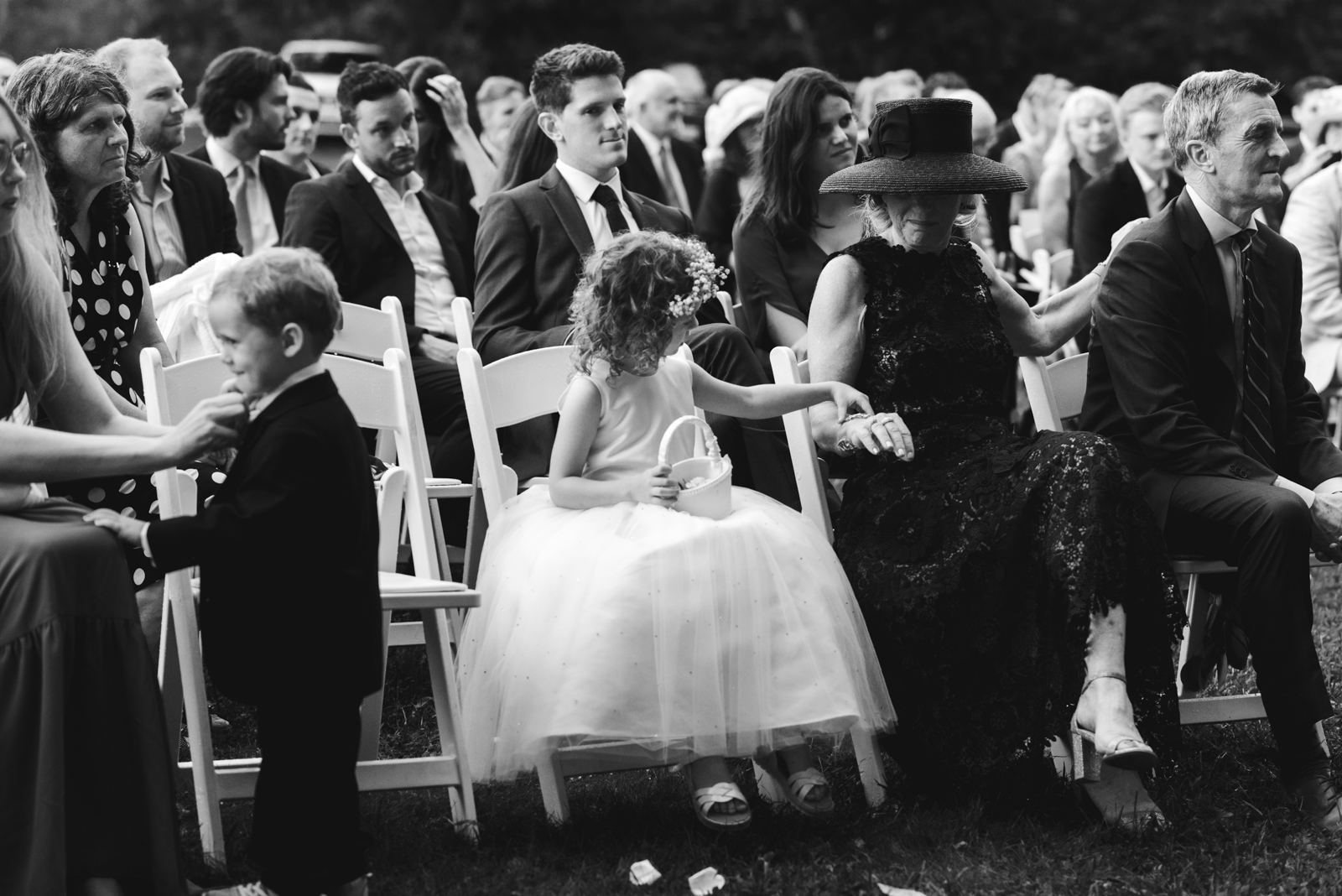 flower girl sitting in the crowd