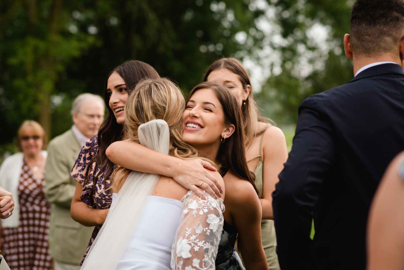 bride hugging a friend after wedding ceremony