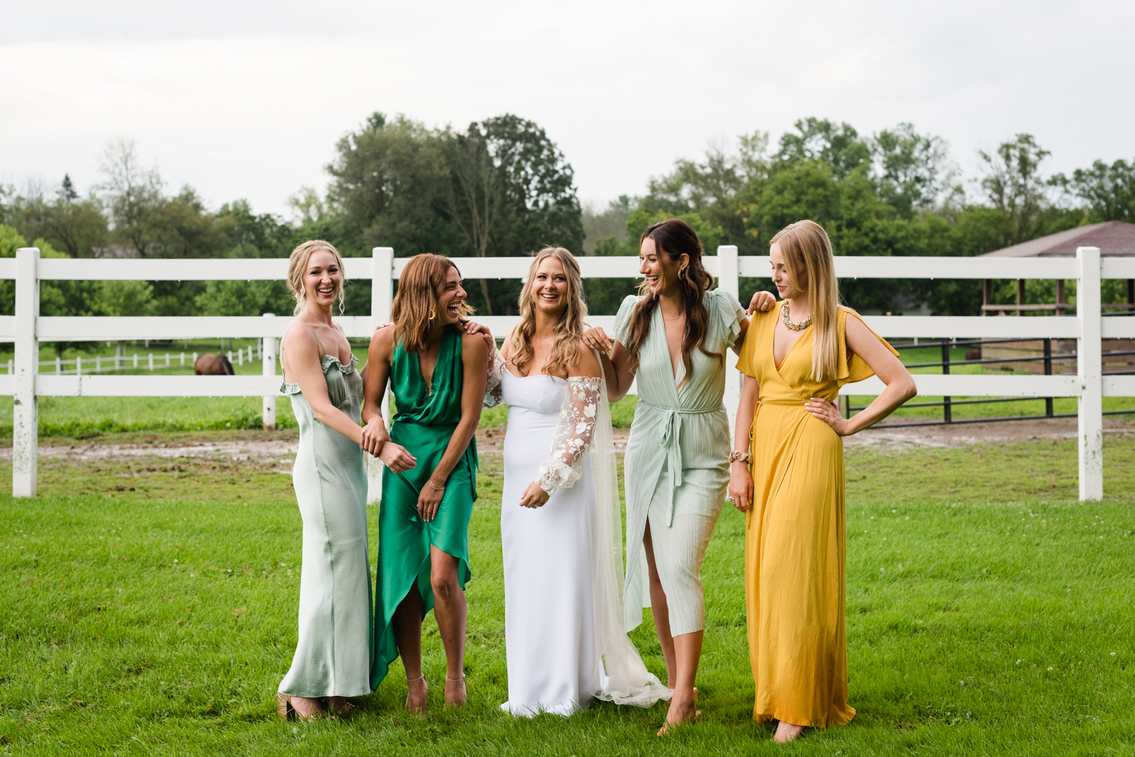 bride and bridesmaids in farmer's fields