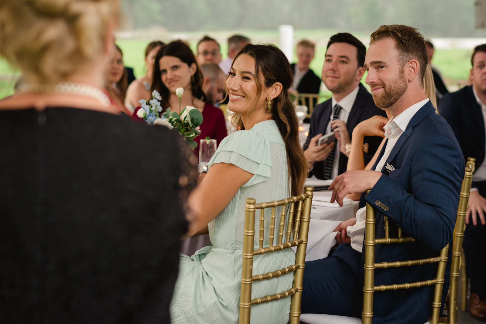 guests smiling during speeches at wedding