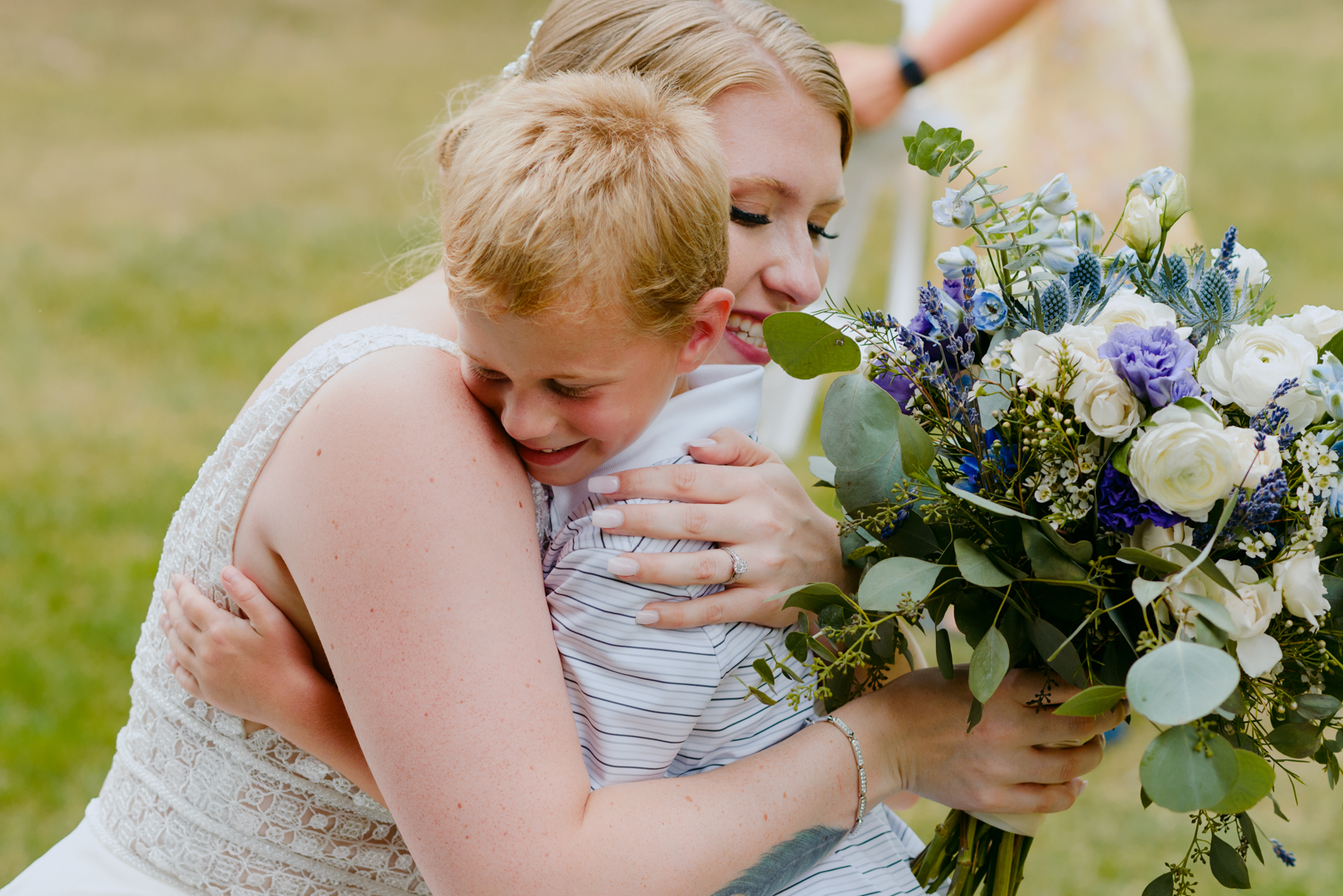 bride hugging her nephew after wedding ceremony