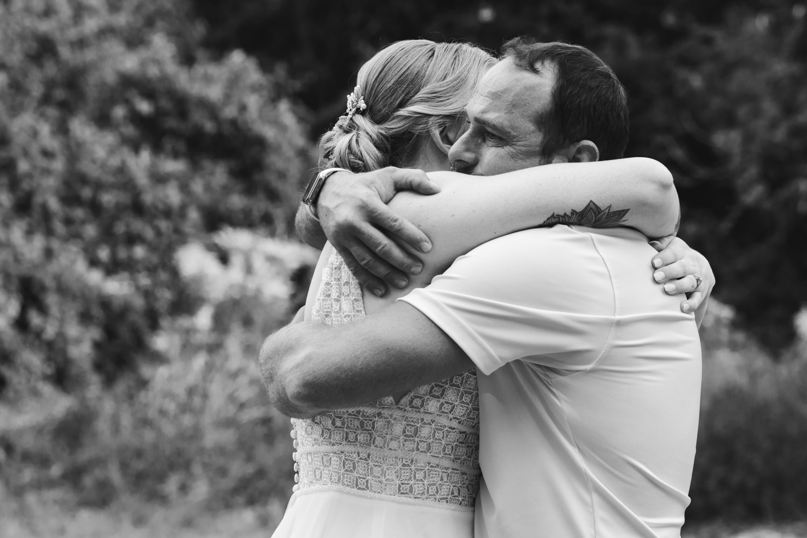 bride hugging her brother after wedding ceremony crying
