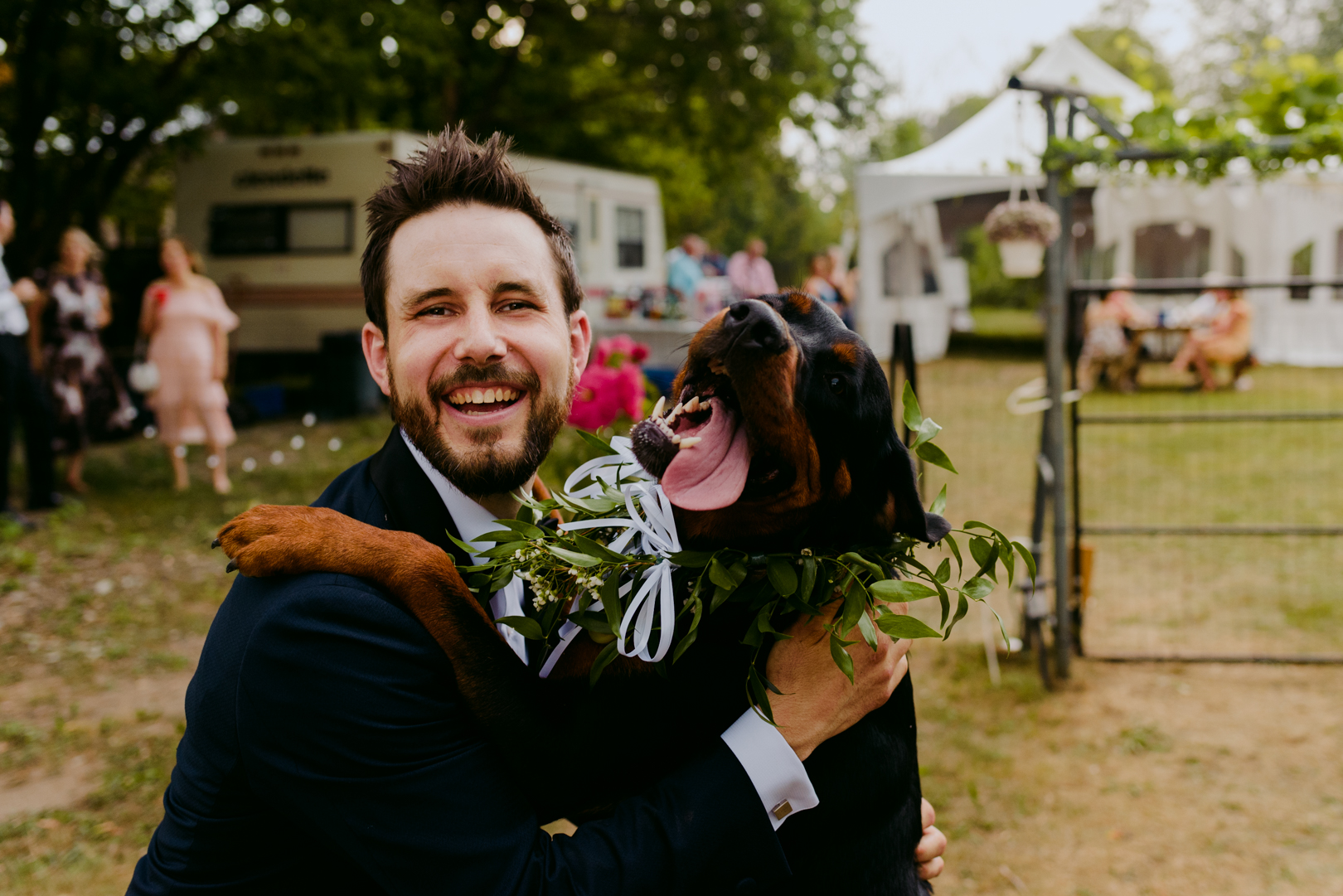 dog smiling with groom on his wedding day
