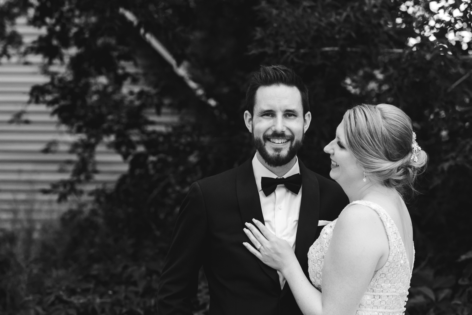 bride smiling at groom in black and white