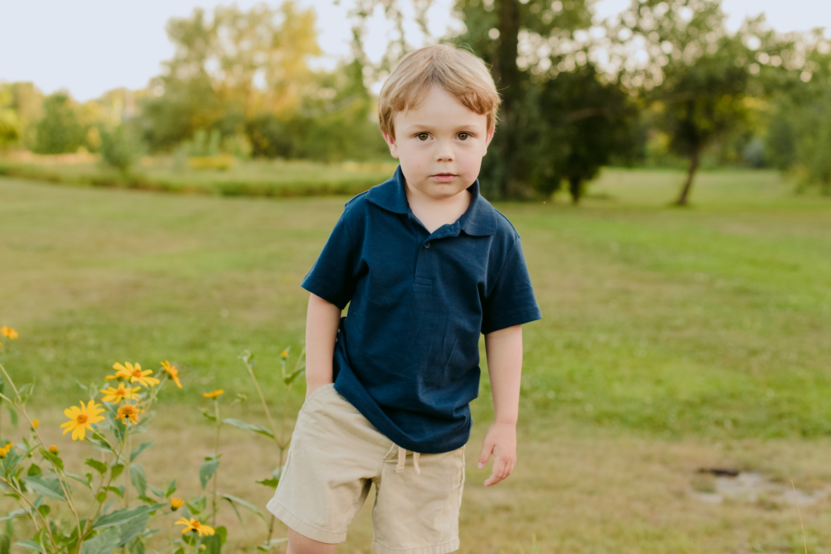 young boy with hand in his pocket outdoors