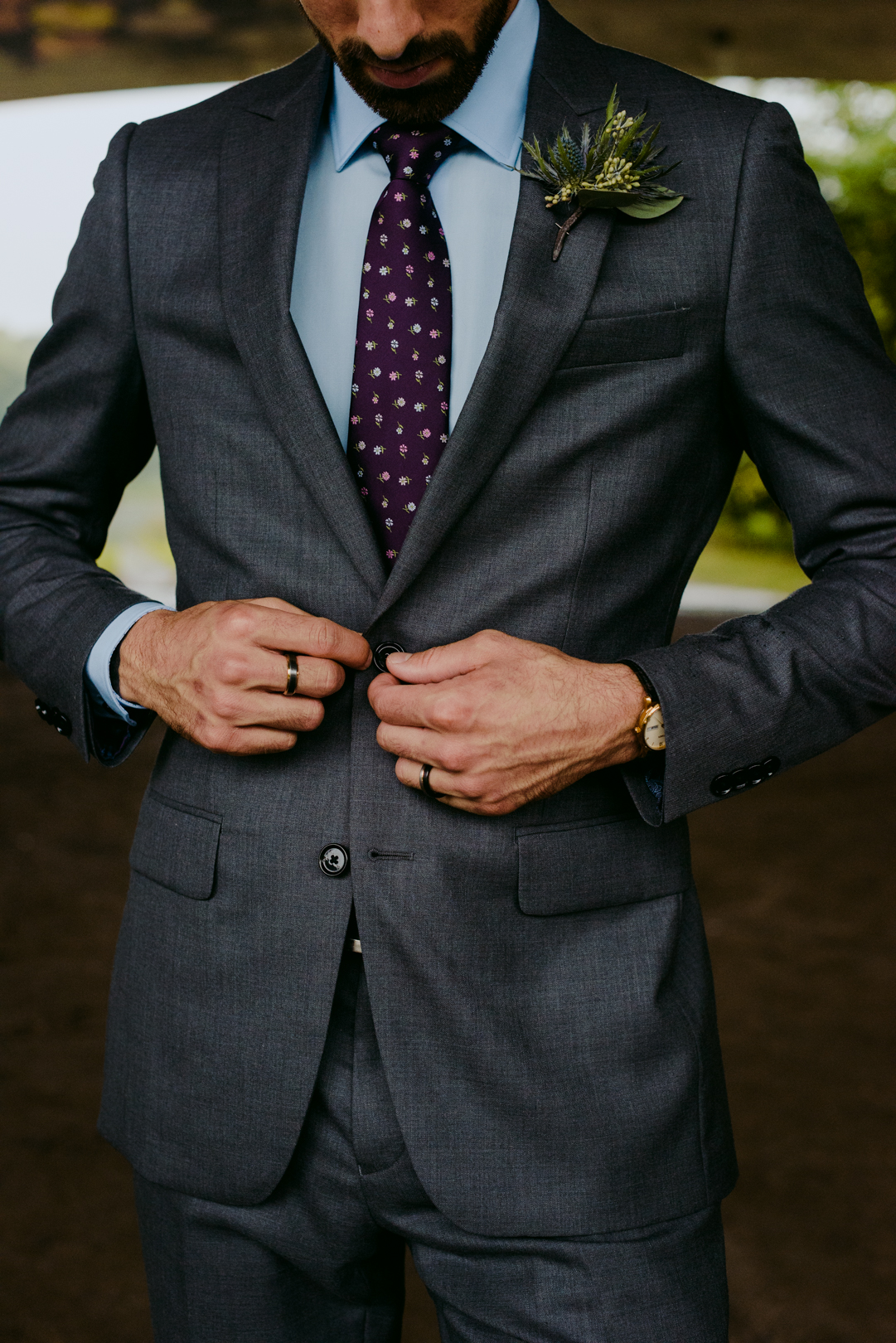 groom tying up suit jacket