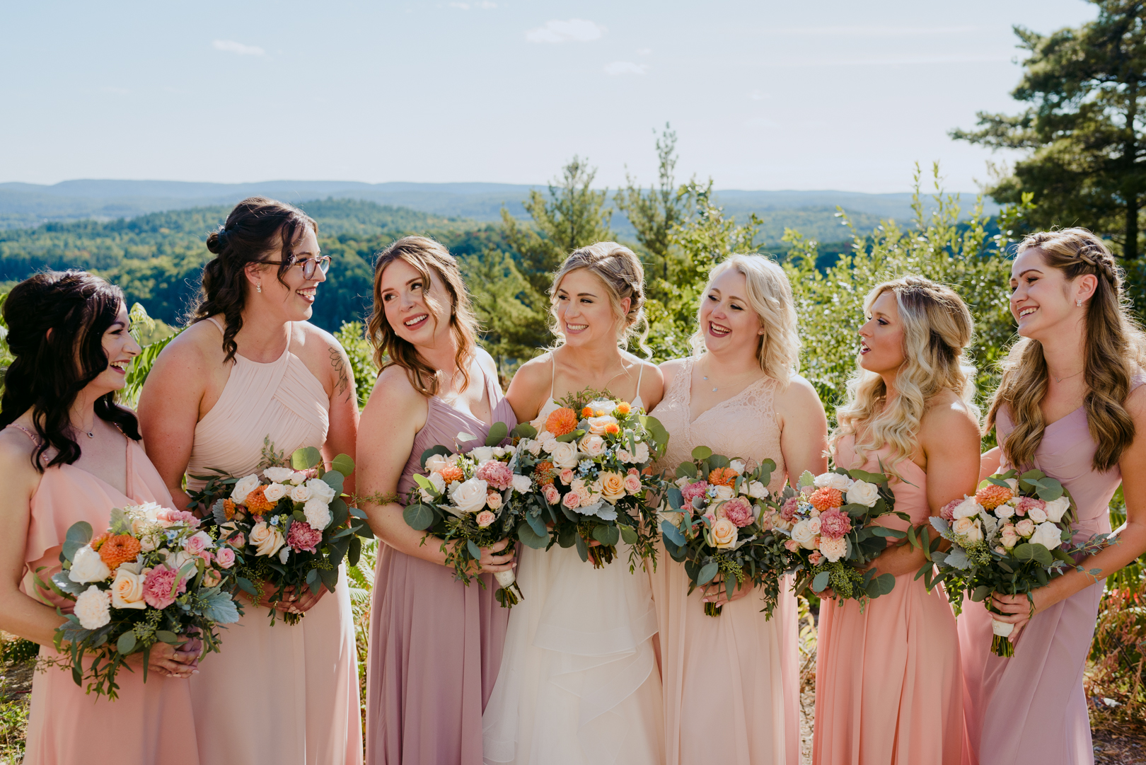 bride and bridesmaids laughing at le belvedere wedding