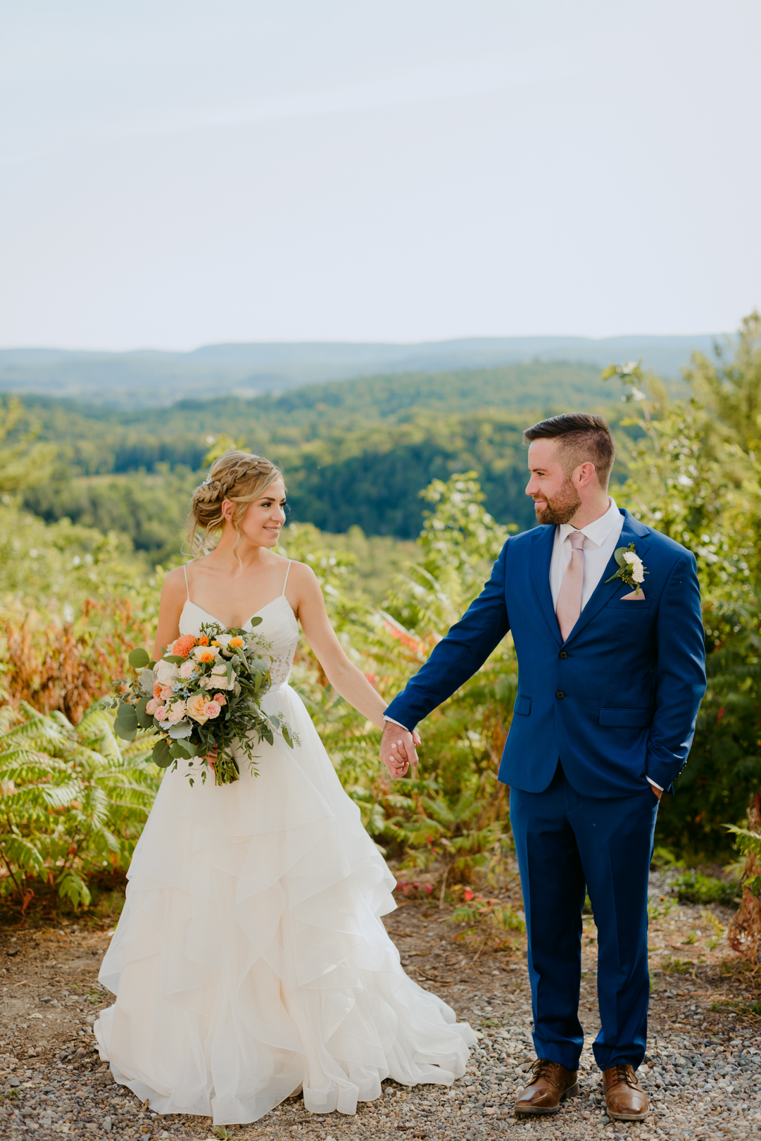 bride and groom with wild floral bouquet at le belvedere wedding
