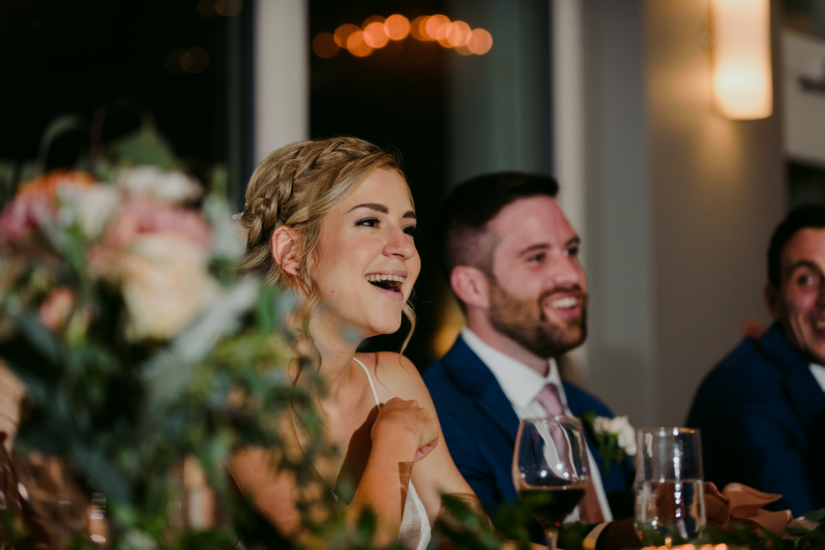 bride laughing during speeches at le belvedere wedding reception