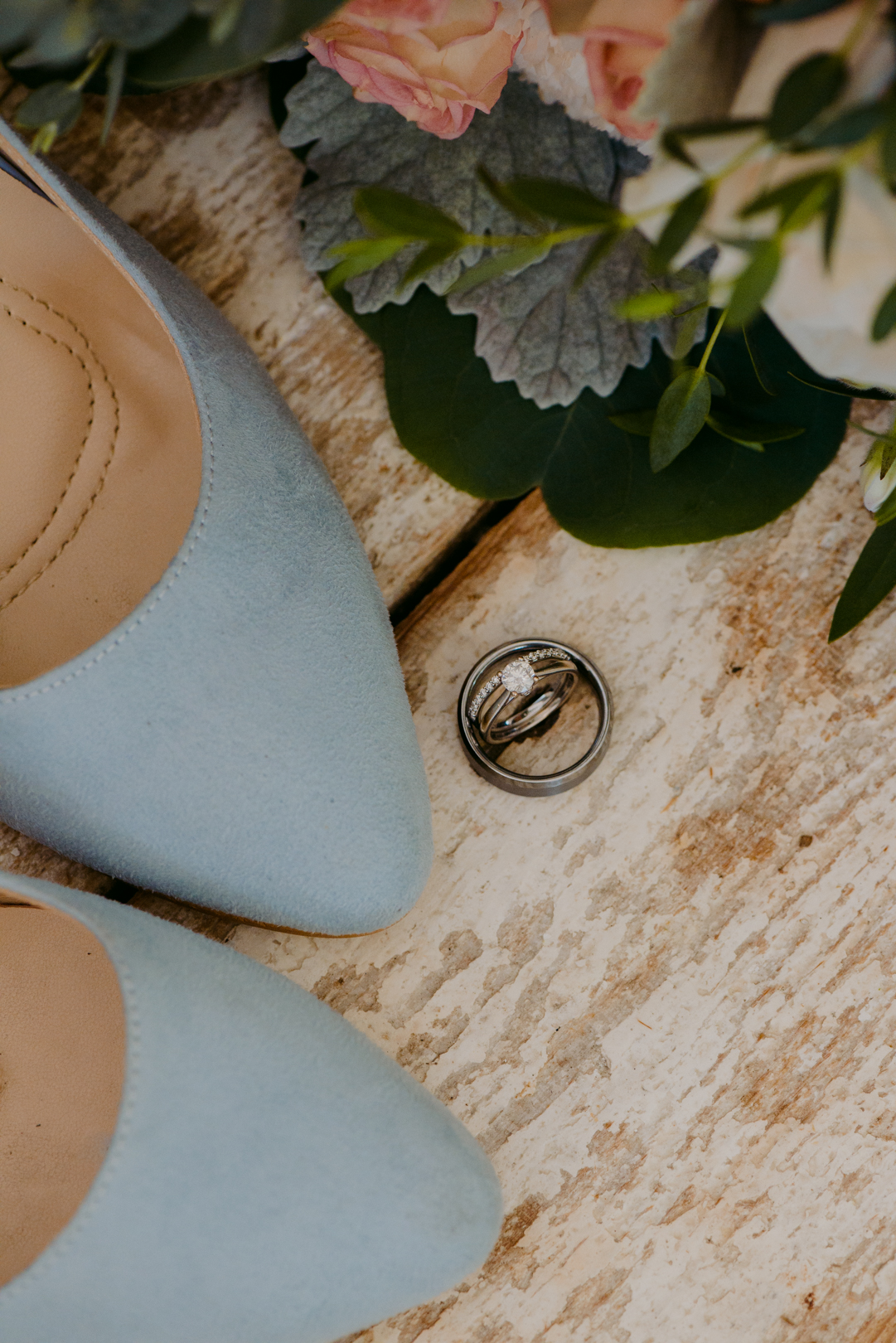 wedding rings and blue shoes with flowers