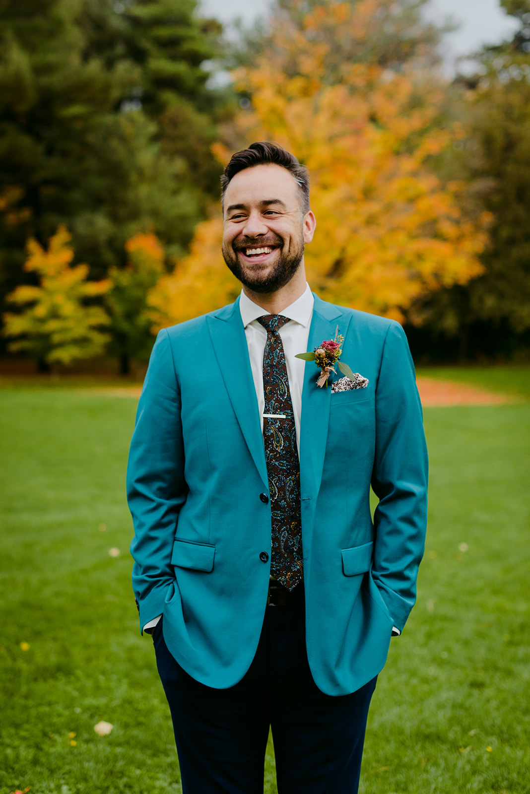 groom in teal coloured suit in rockcliffe park