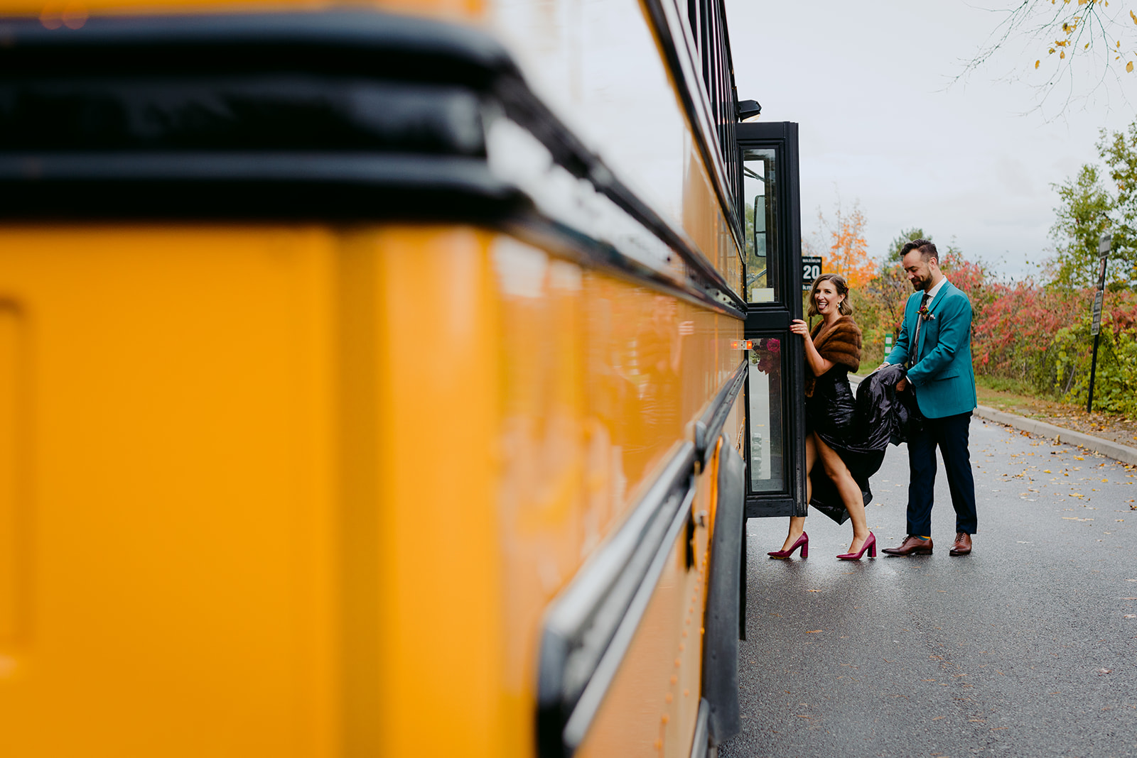 bride and groom getting into yellow school bus