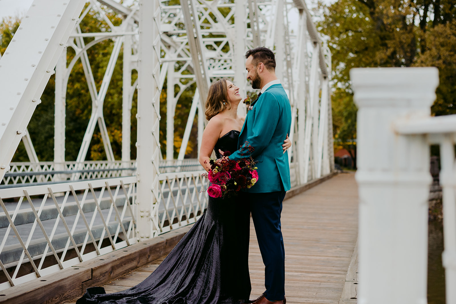 bride and groom at minto bridge on fall day