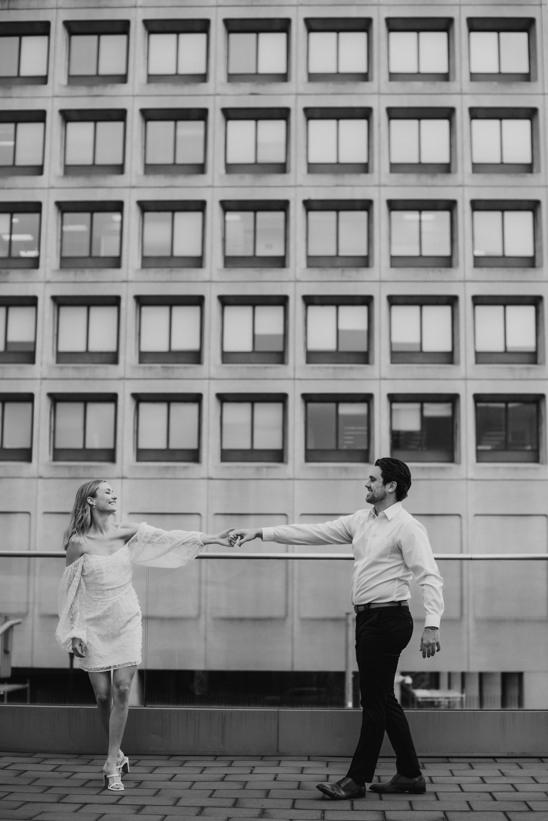 engaged couple dancing in downtown ottawa in black and white