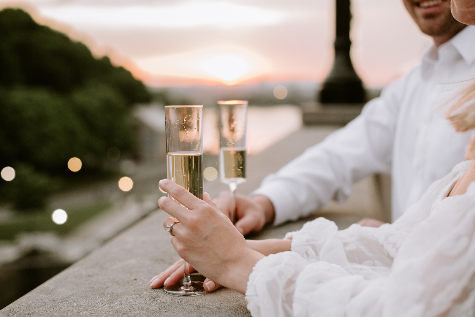 engaged couple on chateau laurier terrace at sunset with champagne
