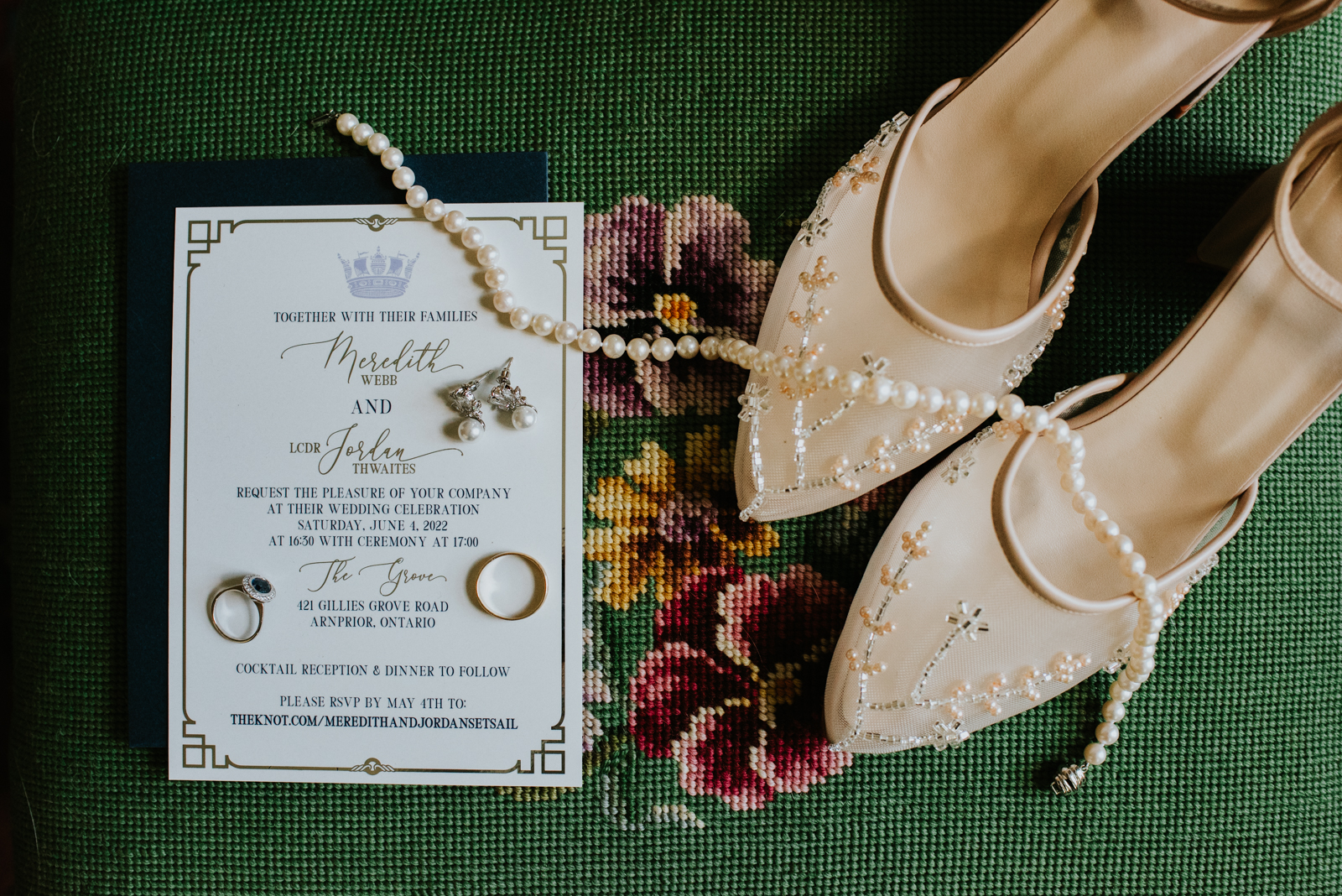 flat lay of wedding invitations and wedding rings and shoes