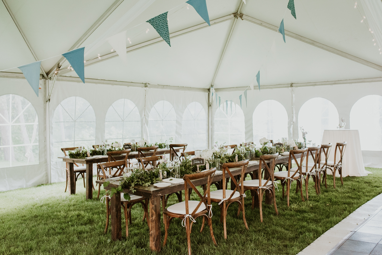tented wedding reception with long harvest tables