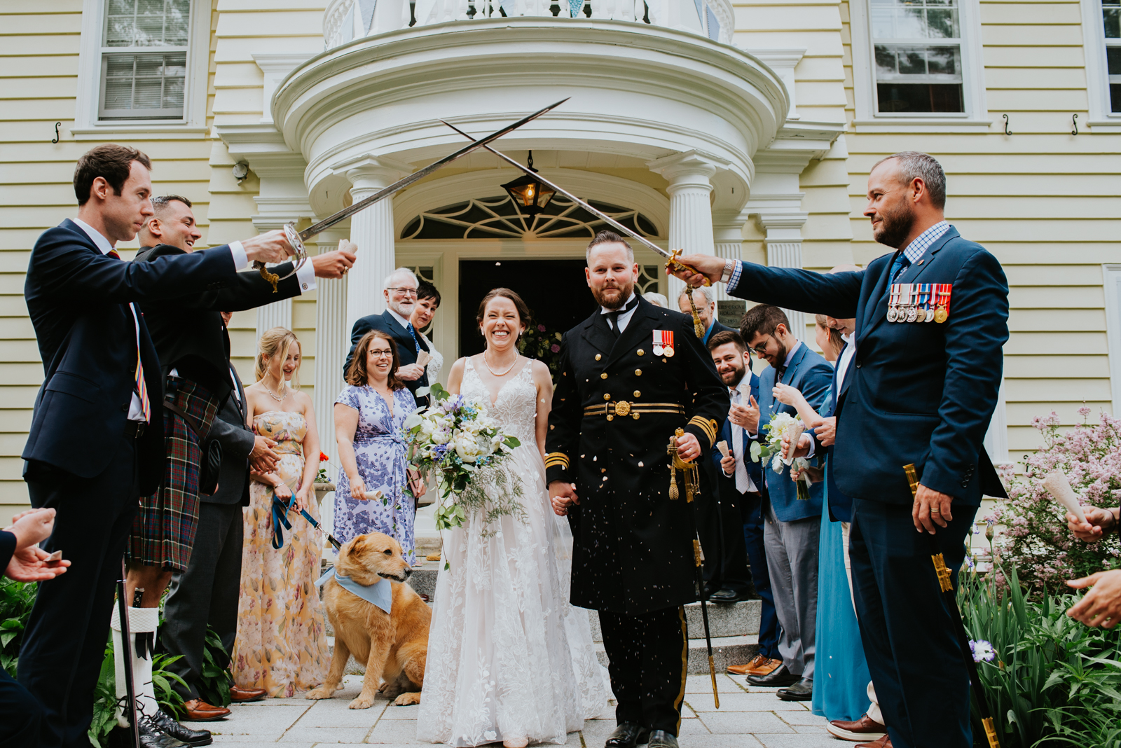 bride and groom in canadian navy uniform sword ceremony after wedding ceremony