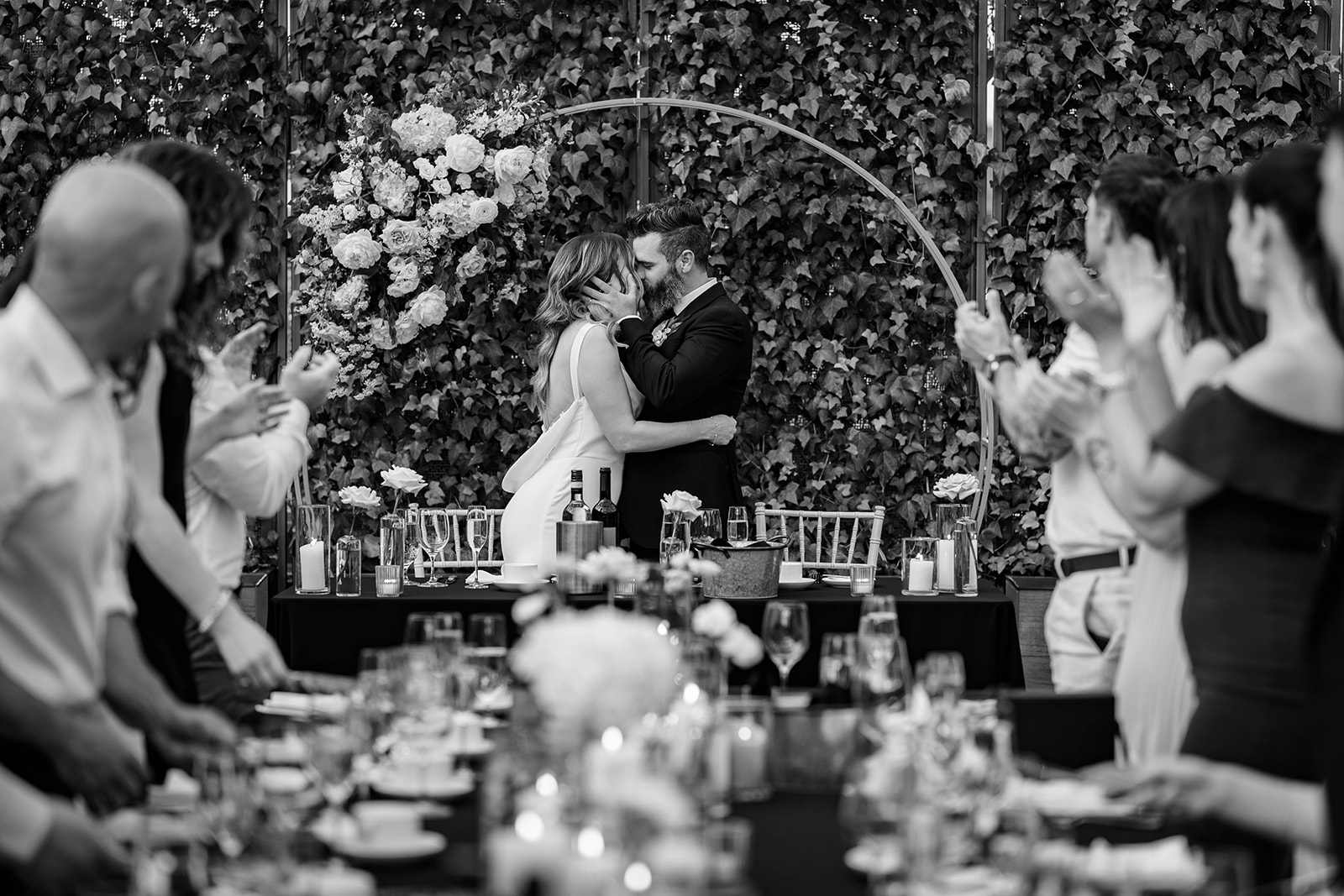 bride and groom kissing at head table at Aquatopia